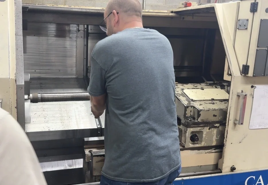 Technician working at CNC lathe
